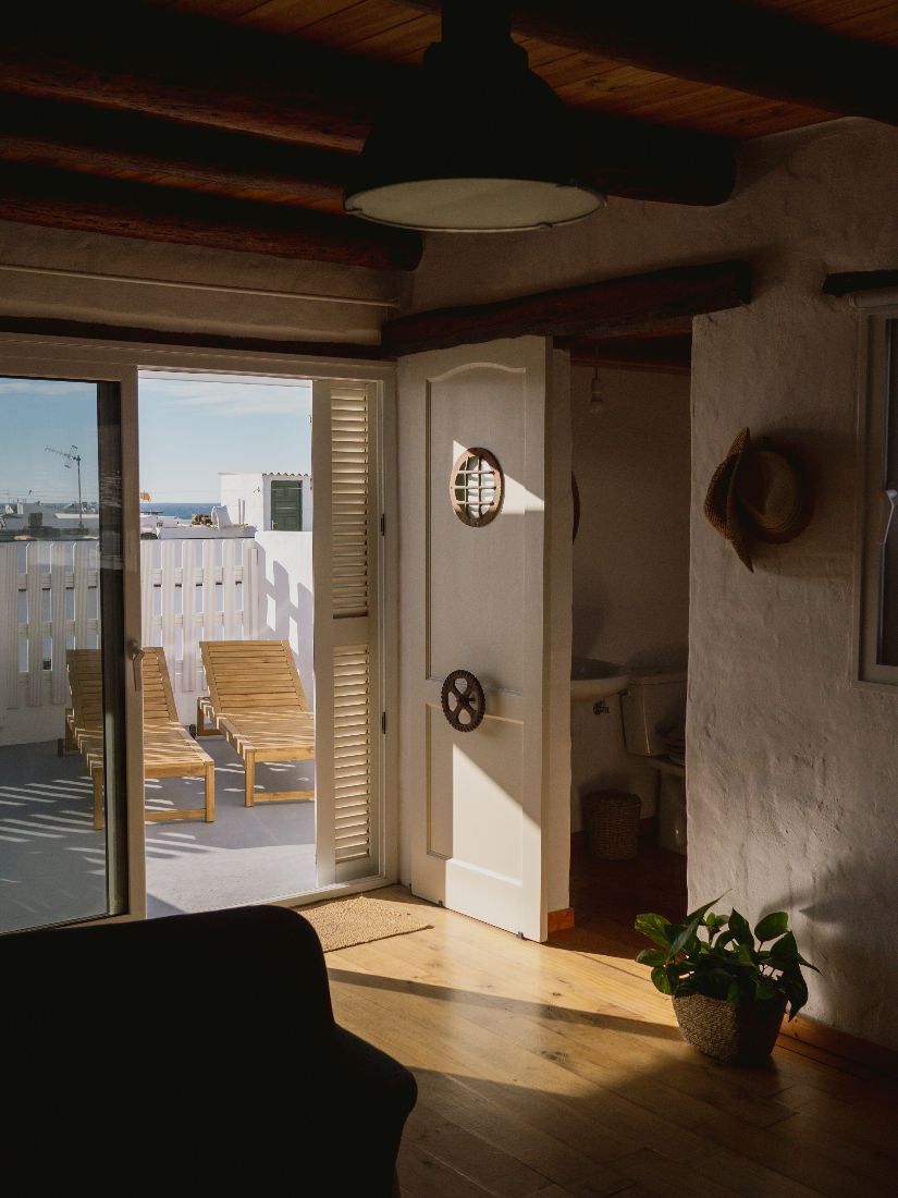 Open door leading out to the roof terrace at golden hour