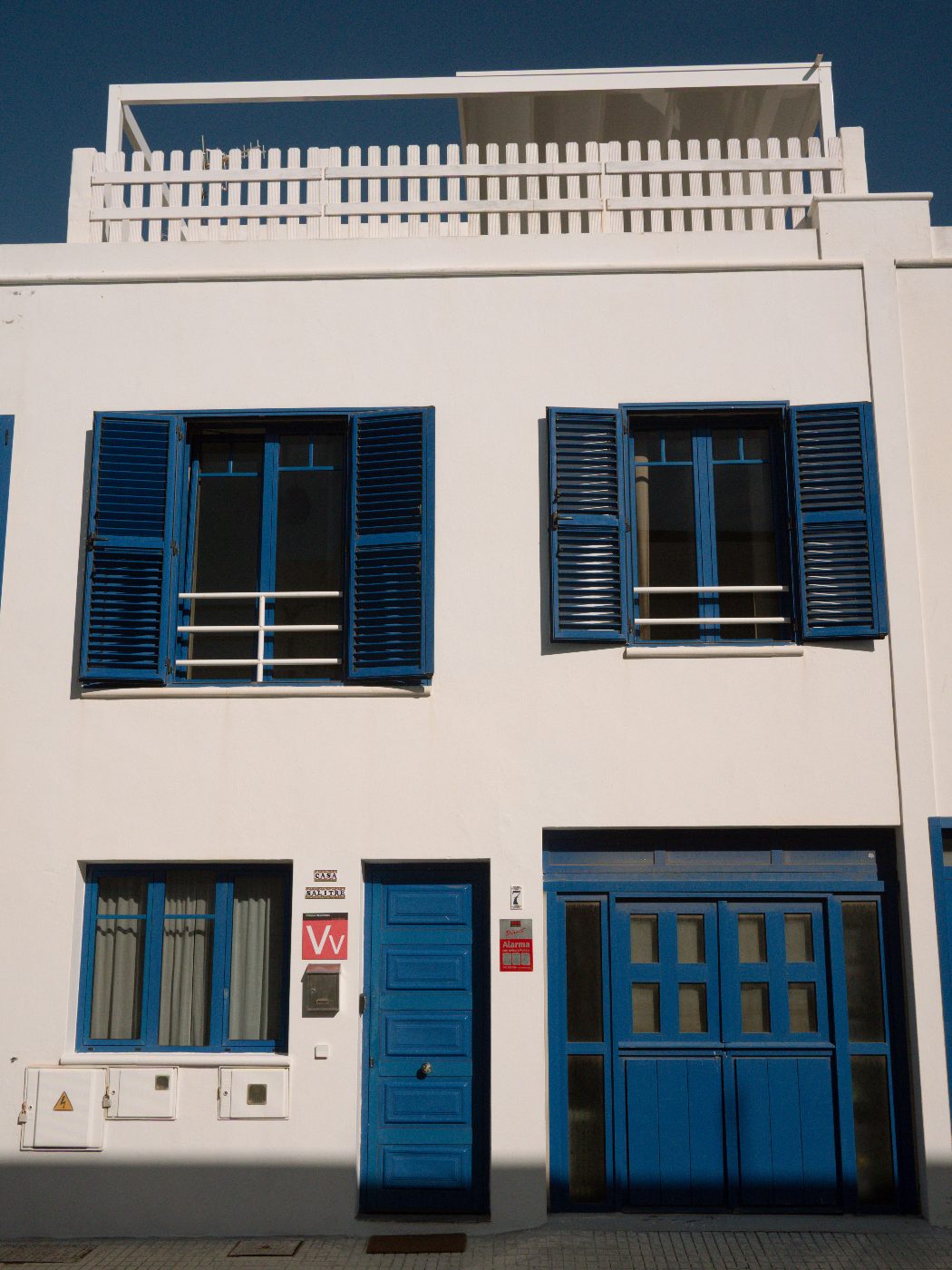 Casa Salitre façade with cobalt-blue shutters and doors