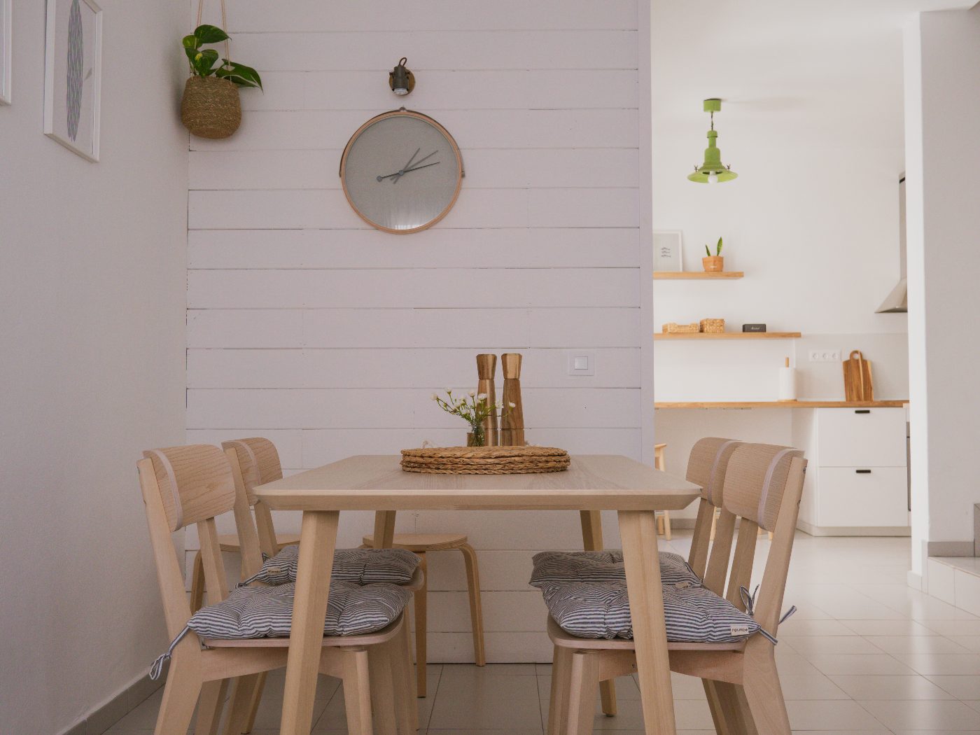 Bright dining room with light wood table and white shiplap wall
